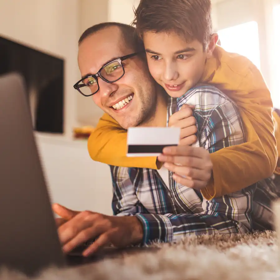 Happy father and son buying online.